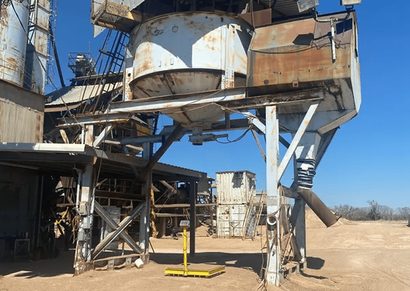Industrial machinery in a dusty outdoor setting.